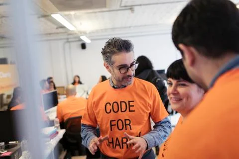 Hackers coding for charity at hackathon Stock Photos