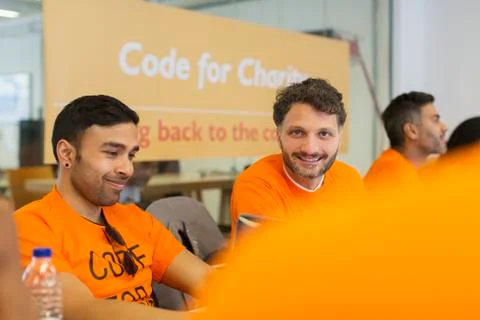 Hackers coding for charity at hackathon Stock Photos