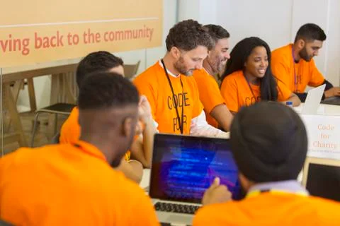 Hackers coding for charity at hackathon Stock Photos
