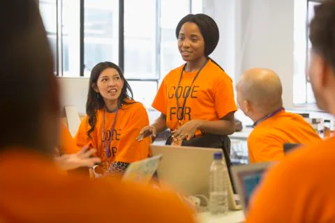 Hackers coding for charity at hackathon Stock Photos
