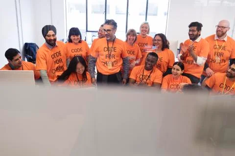 Hackers coding for charity at hackathon Stock Photos