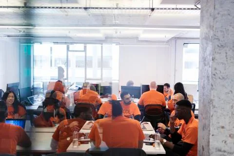 Hackers coding for charity at hackathon Stock Photos
