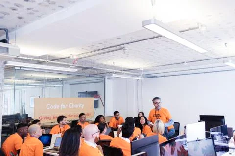 Hackers coding for charity at hackathon Stock Photos