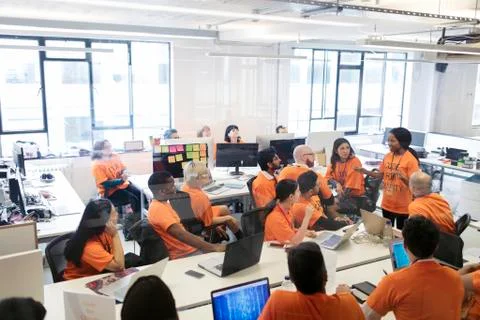 Hackers coding for charity at hackathon Stock Photos