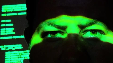 The Hacker's Gaze: Green Code Projection Emphasizing Focused Eyes Stock Footage 342554008
