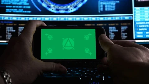 Hackers hands using a smartphone (landscape) in dark office, Stock Footage 107589120