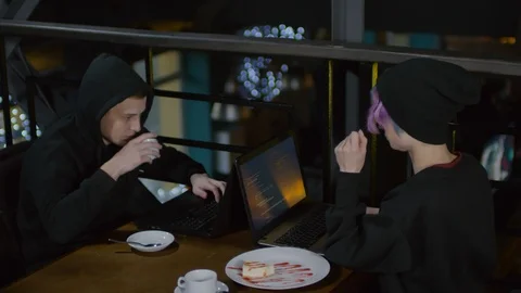 Hackers Having Lunch and Programming in Café Stock Footage 105288678