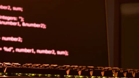 Hacker's keyboard is in the foreground with code scrolling across the Stock Footage 146467003