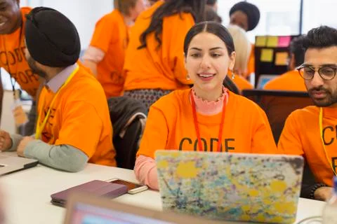 Hackers at laptop coding for charity at hackathon Stock Photos