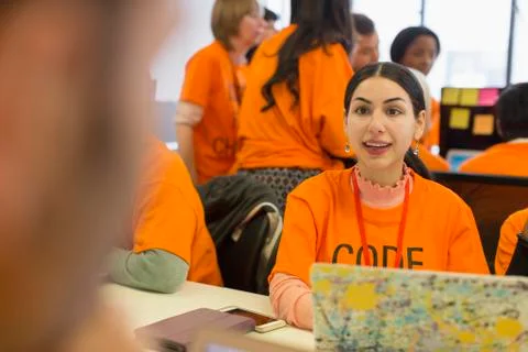 Hackers at laptop coding for charity at hackathon Stock-Fotos
