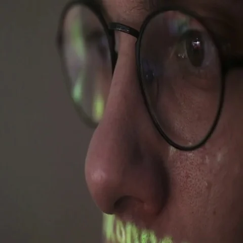 Hackers screen with binary code, data code reflectied in programmer's glasses Video stock 69405643