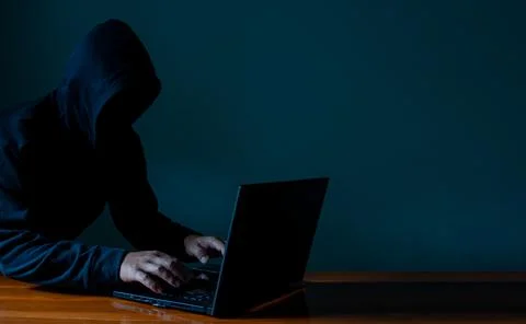 Hackers work on laptops in the dark. The concept of information security in t Stock Photos