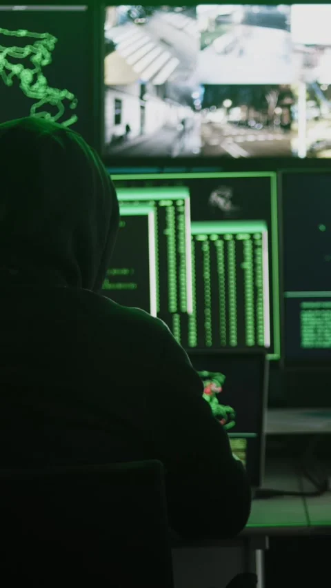 Hackers working on computers showing world maps and security camera footage Stock Footage 346787788