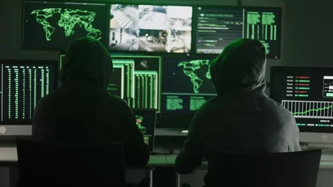 Hackers working on computers showing world maps and security camera footage Stock Footage 346787869