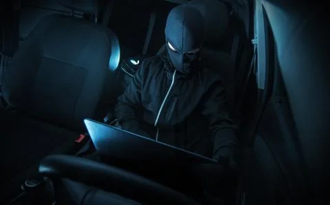 Hacking Car Systems. Hacker with His Computer at Work. Stock Photos