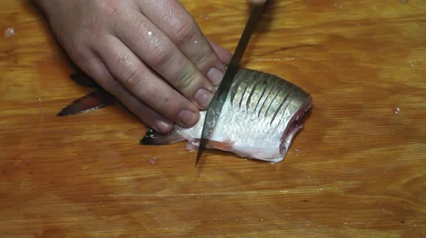 Hacking fish bones Stock Footage 36004756