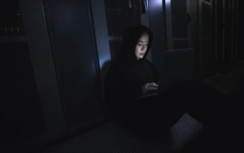 Hacking, laptop and hacker woman in dark server room for coding software, data Stock Photos