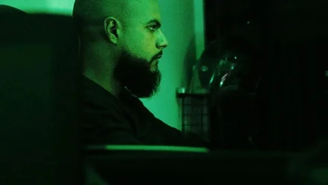 Hacking in progress ( hacker seen from the side - profile ) 4K Video stock 94186864