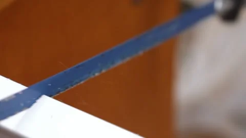 Hacksaw blade cutting a white plastic cable trunking Video stock 327158435