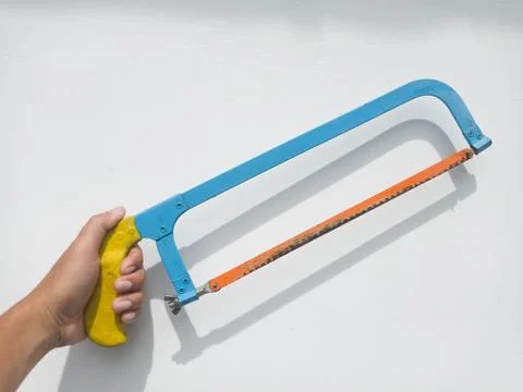 Hacksaw tool held in hand Stock Photos