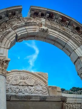 Hadrian Temple Arch Frames Azure Sky with Ornate Carvings Фото