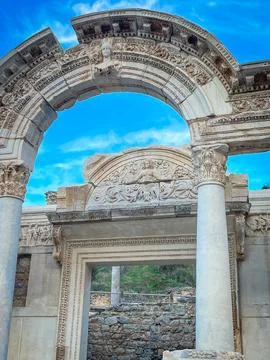 Hadrian Temple Archway Frames Vivid Blue Sky with Ornate Reliefs Ephesus 스톡 사진