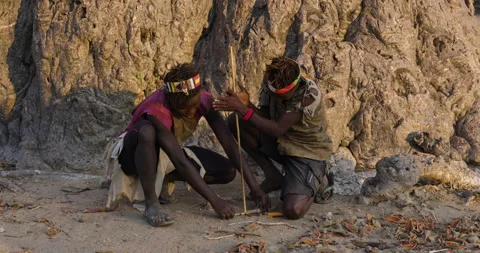 Hadza hunter-gatherer tribesmen making a fire traditional way Tanzania Stock-Footage 160994946