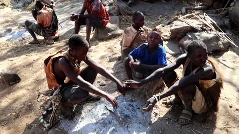 Hadzabe African tribe getting warm with ashes in the outdoor Video stock 228521899