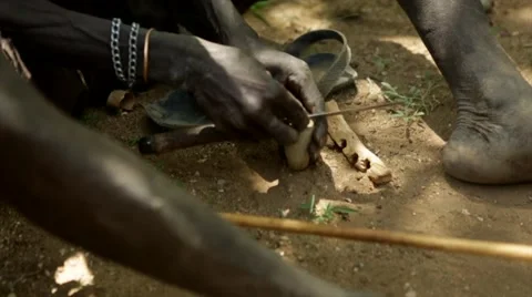 Hadzabe tribe man smoking a pipe Stock Footage 49010792