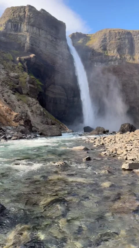 Haifoss waterfall viewed from below with clear river water and rocks, Iceland Stock Footage 331513911