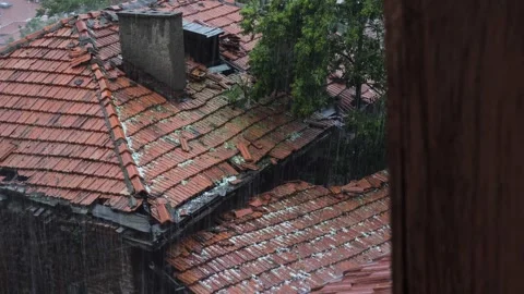 Hail and rain are falling on the briquette roof of the old house Stock Footage 277540418