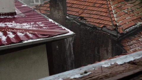Hail and rain are falling on the briquette roof of the old house Stock Footage 277541358
