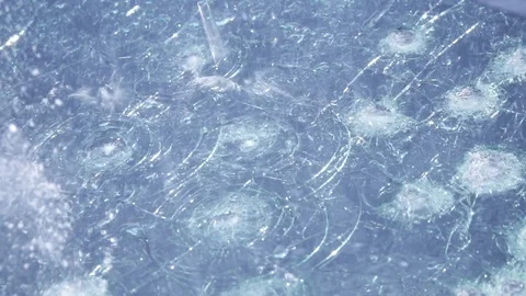 Hail damage on wind shield cracked a n broken from the ice slow motion Stock Footage 104061348