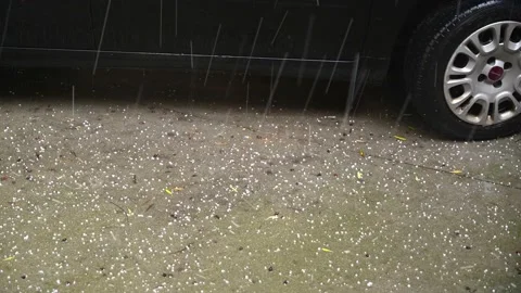 Hail falling  and a parked car Stock Footage 166115840