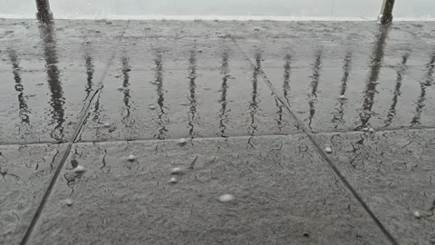 Hailstones falling onto the porch surface, close-up Видео 338020747