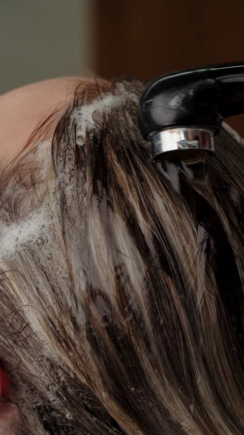Hair being washed with shampoo under salon faucet Stock Footage 311163953