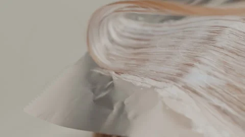 Hair bleaching process, Detailed scene of hair color transformation with bleach Stock Footage 327481131