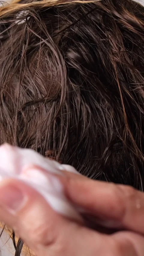 Hair care mask, close-up of the process of applying it to hair by hand Stock Footage 311768444