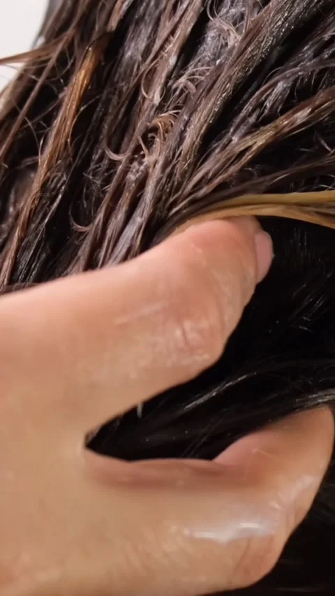 Hair care mask, close-up of the process of applying it to hair by hand Stock Footage 312643647