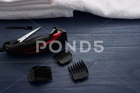 Hair Clipper and scissor the hairdressing salon on a wooden table Stock Photos