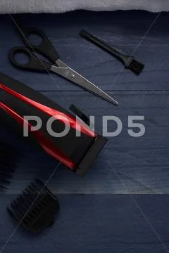 Hair Clipper and scissor the hairdressing salon on a wooden table Stock Photos