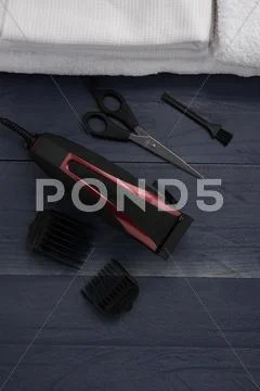 Hair Clipper and scissor the hairdressing salon on a wooden table Stock Photos