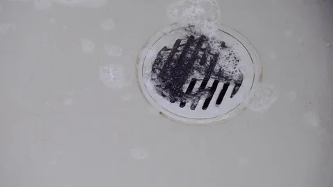 Hair clump in bath drain while taking a shower. Stock Footage 72642306