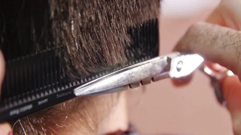  Hair Cutting Scissors through a Comb.  Macro Shooting. Slowmotion Stock Footage 105263864