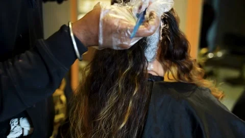 Hair dye application on parted section Stock Footage 325184474