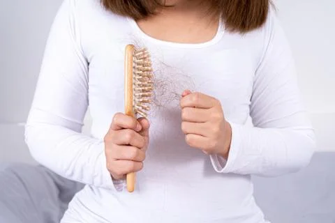 Hair fall problem, closeup hand holding comb and problem hair. Healthcare med Stock Photos