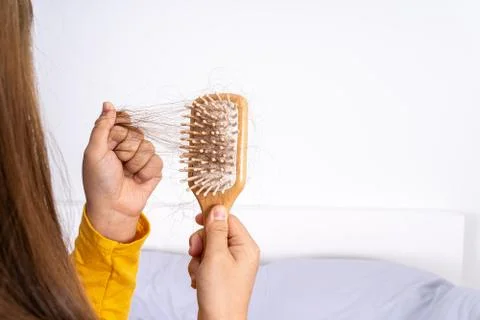 Hair fall problem, closeup hand holding comb and problem hair. Healthcare med Stock Photos
