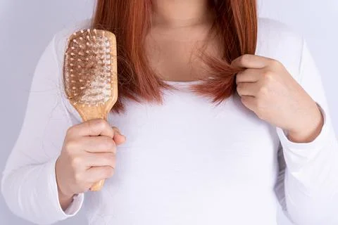 Hair fall problem, closeup hand holding comb and problem hair. Healthcare med Stock Photos