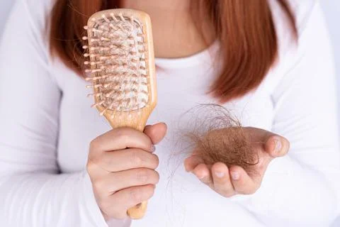 Hair fall problem, closeup hand holding comb and problem hair. Healthcare med Stock Photos