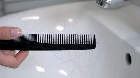 Hair left on the comb after brushing the hair. Hair loss problem Stock Footage 143560396